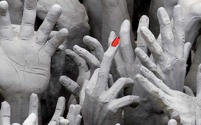White hands arise from the underworld, with a different meaning for Buddhism and animism.
