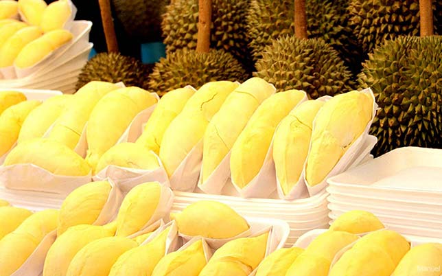 Durian stall in a market, a famous and controversial tropical fruit.