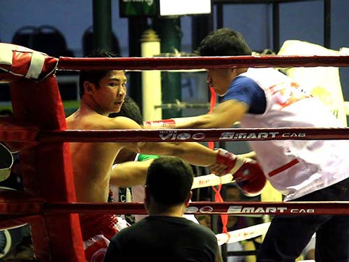 Rest between rounds in a Muay Thai fight.